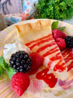 Slice of Water Depression Pie with Fresh berries and raspberry sauce
