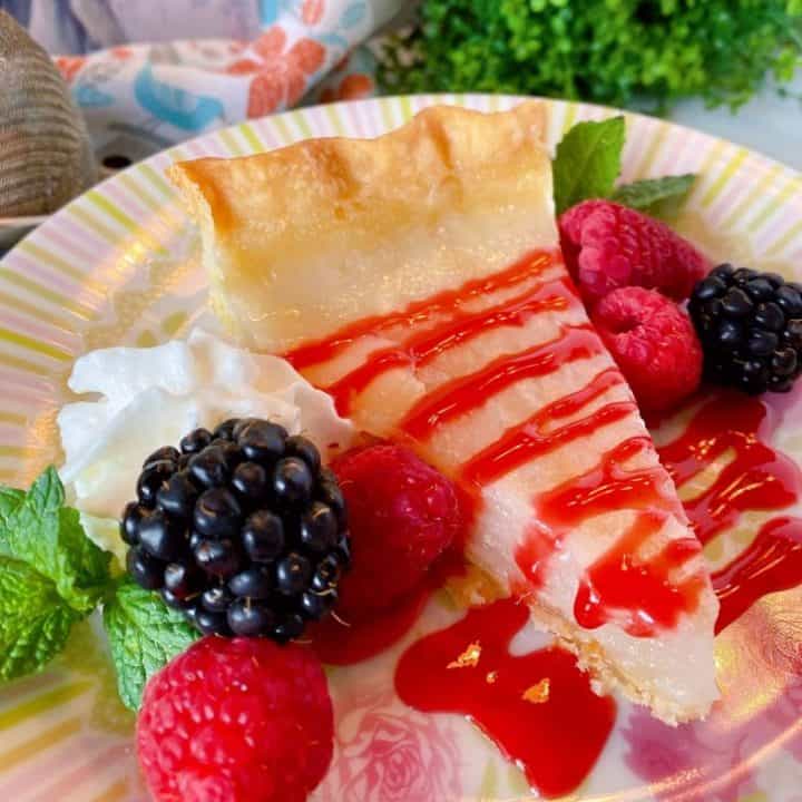 Slice of Water Depression Pie with Fresh berries and raspberry sauce