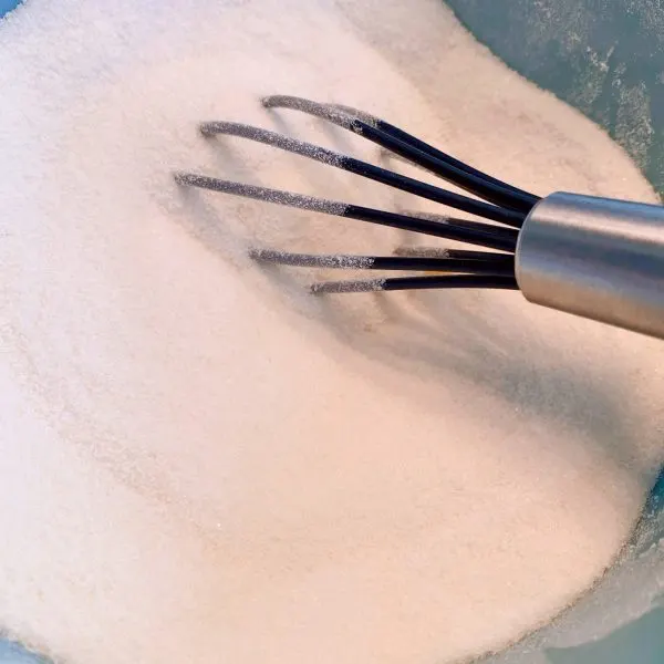 Flour and Sugar in a small bowl being whisked together.