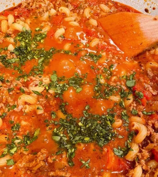 Adding the fresh chopped Italian Parsley to goulash