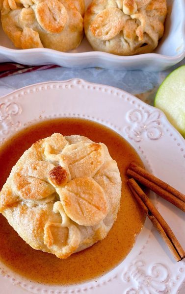 Apple Dumpling with Rich Cinnamon Sauce on a dessert plate.