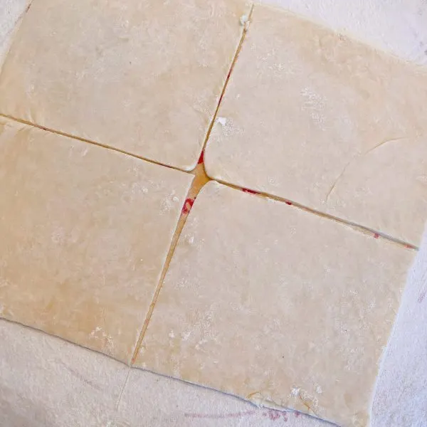 Pie dough cut into 4 equal 6 inch squares to wrap apples in for dumplings.