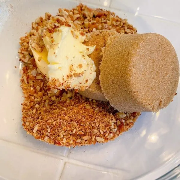 Butter, pecans, brown sugar, and cinnamon for apple filling in a bowl.