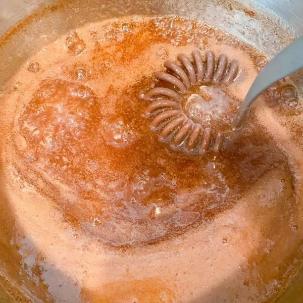 Cinnamon Sauce in sauce pan with whisk.