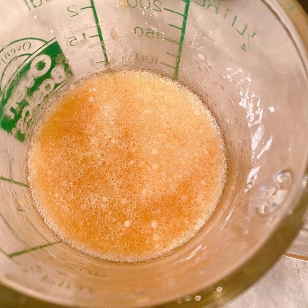 Water and Cornstarch combined in a small measuring cup.