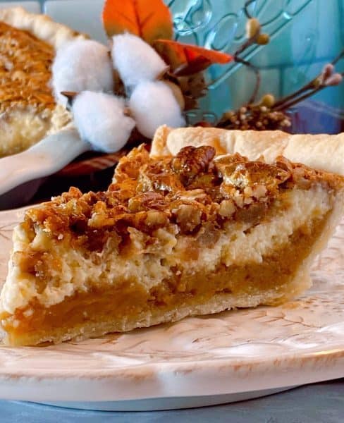 One slice of Caramel Pecan Cheesecake Pie on a plate ready to eat.