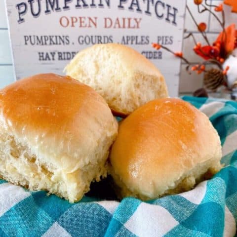 Basket full of dinner rolls.