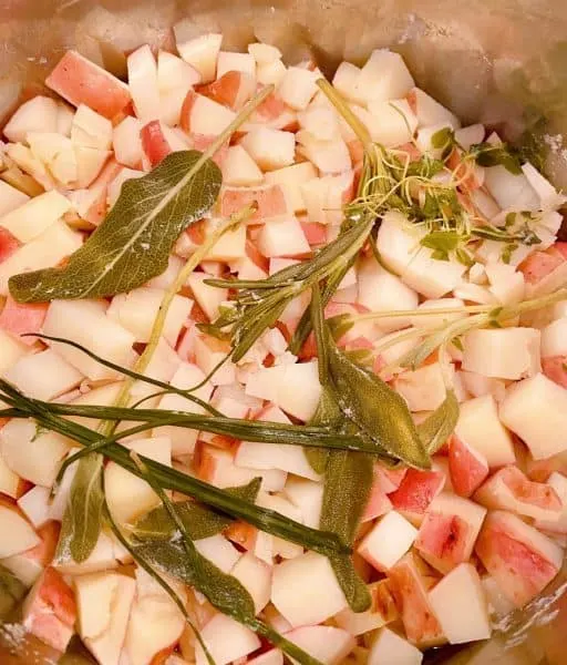 Cooked potatoes with cooked herbs in the instant pot cooling down.