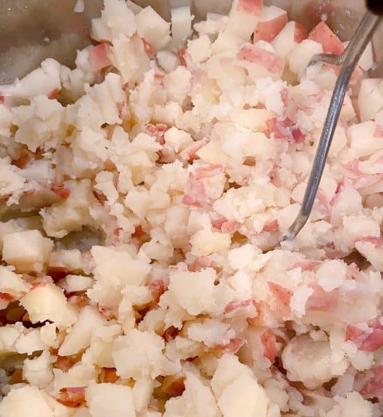 mashing potatoes with hand potato masher