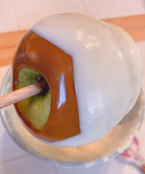 Dipping apples in melted white chocolate