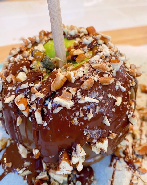 Caramel apple drizzled with dark chocolate and chopped pecans.