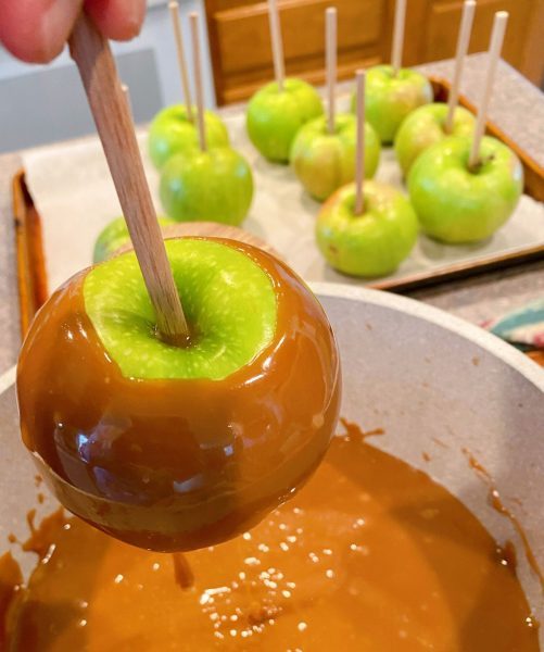 Caramel dripping off the apple into the pan