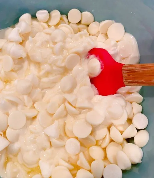 White chocolate chips in microwave safe bowl melted.