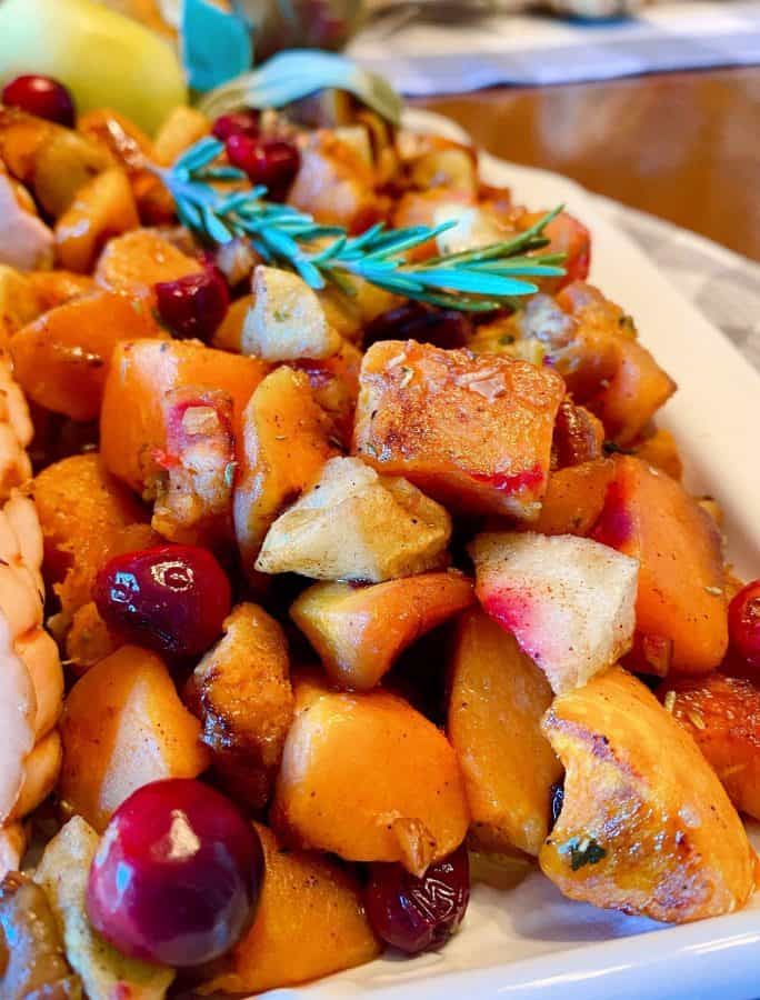 Platter with roasted butternut squash, cranberries, and apples.