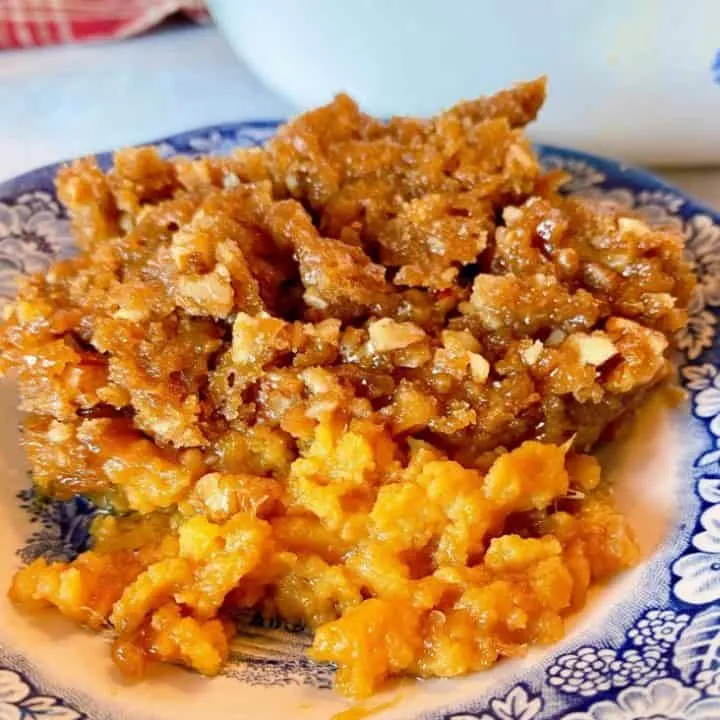 Serving of Sweet Potato Casserole on Blue Transferware plate.