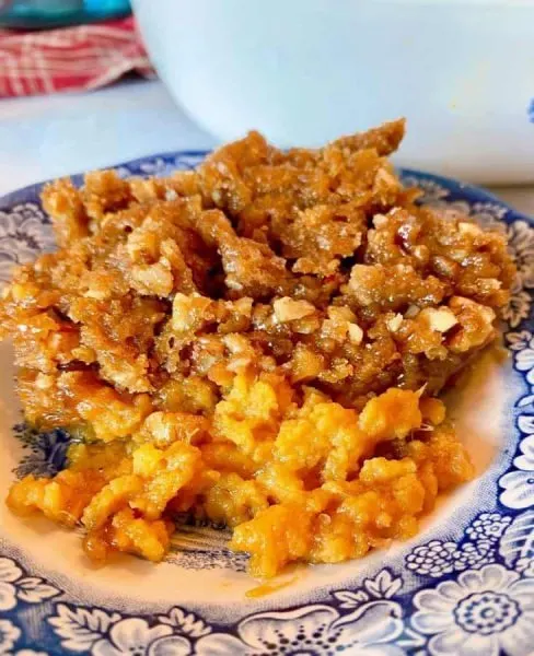 Serving of Sweet Potato Casserole on Blue Transferware plate.