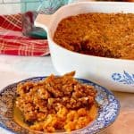Sweet Potato Pecan Casserole in the casserole dish and a plate full of the casserole.