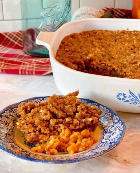 Sweet Potato Pecan Casserole in the casserole dish and a plate full of the casserole.