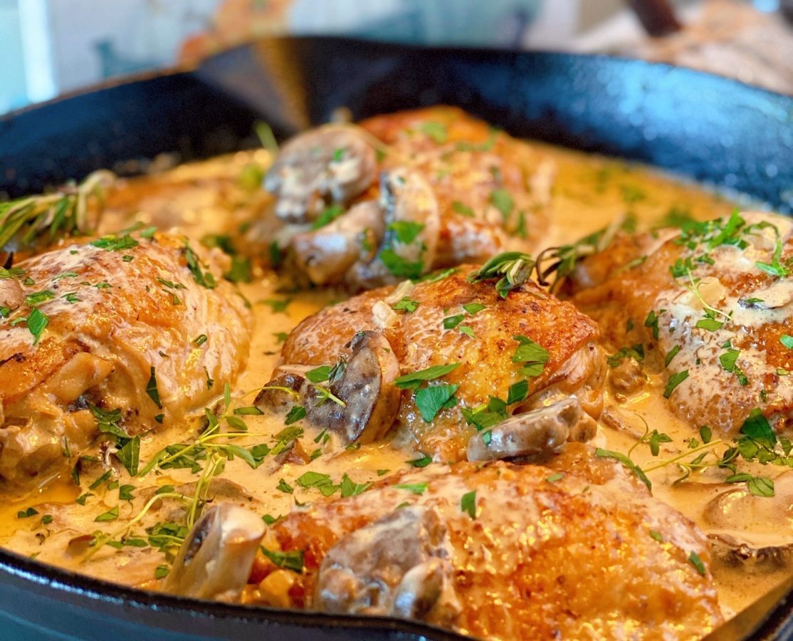 Skillet full of Chicken Thighs in Mushroom Cream Sauce