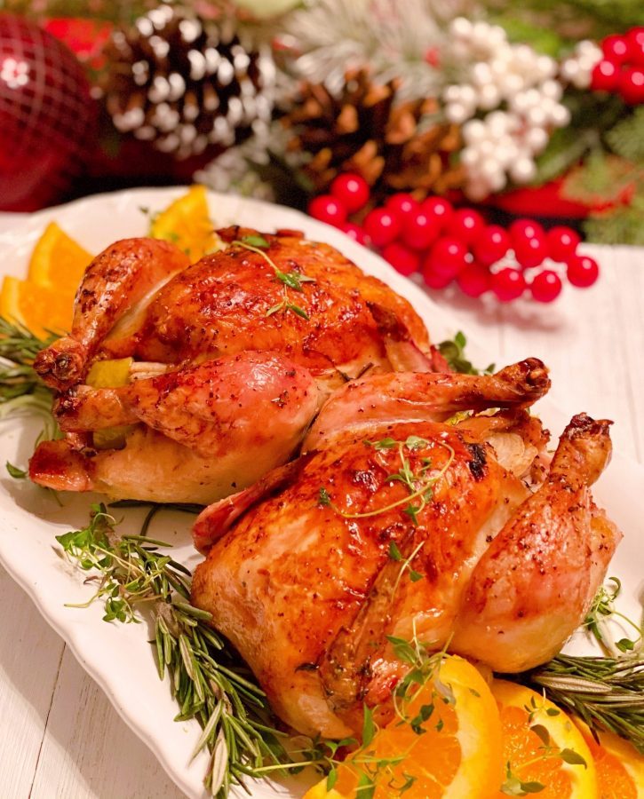 Roasted Cornish Game Hens on a platter with herbs