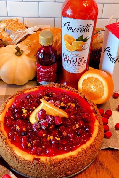 Cranberry Orange Cheesecake with extracts in the background