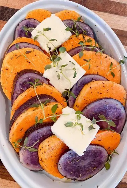 Potatoes and Sweet Potatoes in baking dish ready for baking.
