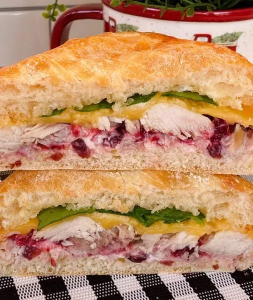 Hot Turkey Sandwich with Cranberry Sauce cut in half and stacked.
