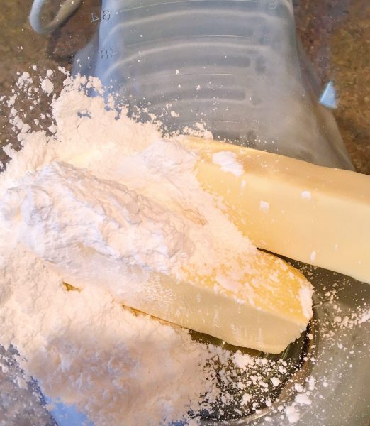 Butter and confectioners sugar in bowl of mixer