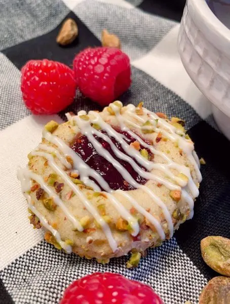 Raspberry Pistachio Cookie close up with white chocolate drizzle