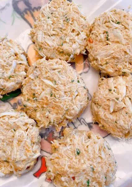 crab mixture shaped into cakes on a plate