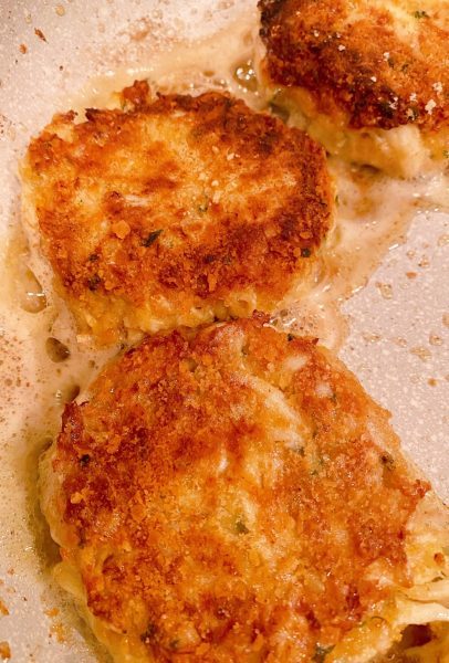 cooking crab cakes in a skillet