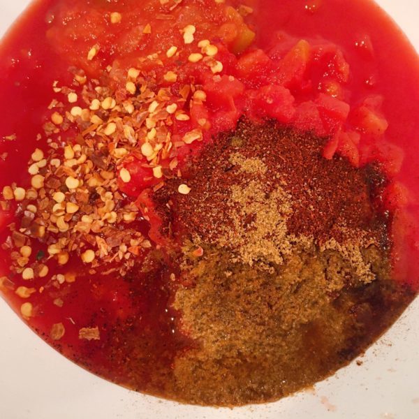 Bowl with red sauce ingredients ready to be combined.