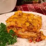 Close up of a slice of Mexican Lasagna on a plate.