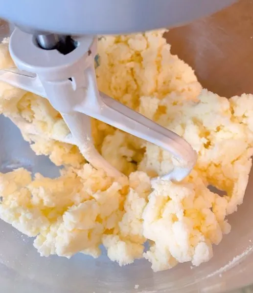 Mixing sugar and butter until light and fluffy.