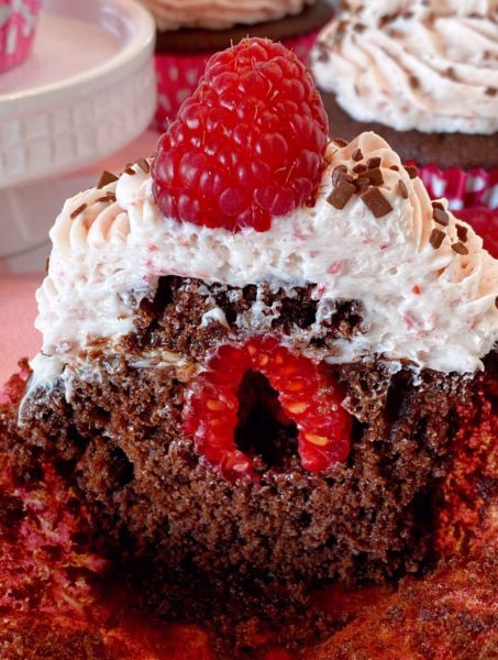 Inside the cupcakes with raspberry and chocolate ganache. 