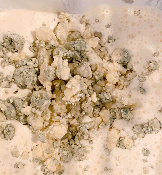 Adding Blue Cheese Crumbles to dressing in blender.