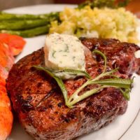 Pan-seared Filet Mignon with Herbed Butter on a serving plate.