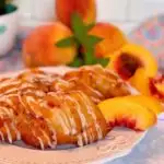 Fresh Peach Fritters on a white plate with fresh peach slices.