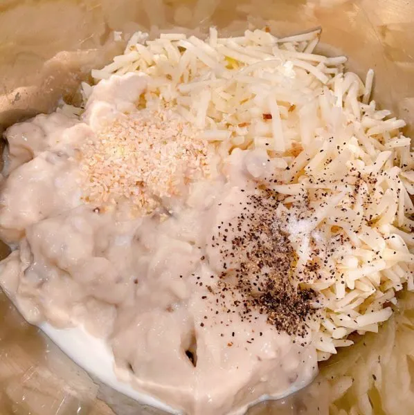 Potato ingredients in a mixing bowl ready to combine.