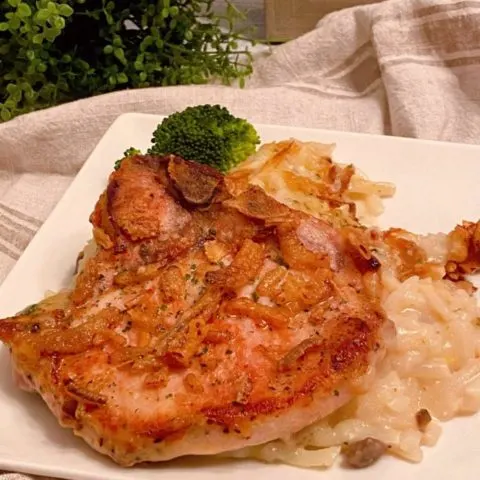 Pork Chop with scalloped potatoes on a plate.