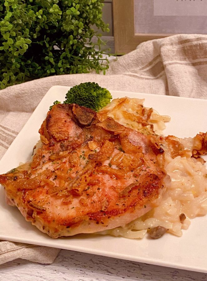 Pork Chop with scalloped potatoes on a plate.