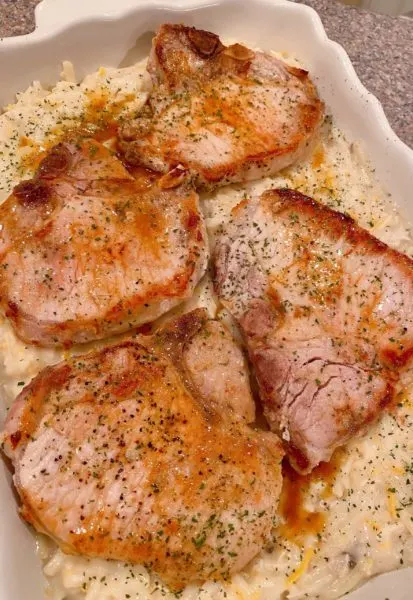 Browned pork chops on top of creamy potato mixture.