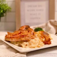 Pork Chop and Potatoes on a serving plate ready to eat.