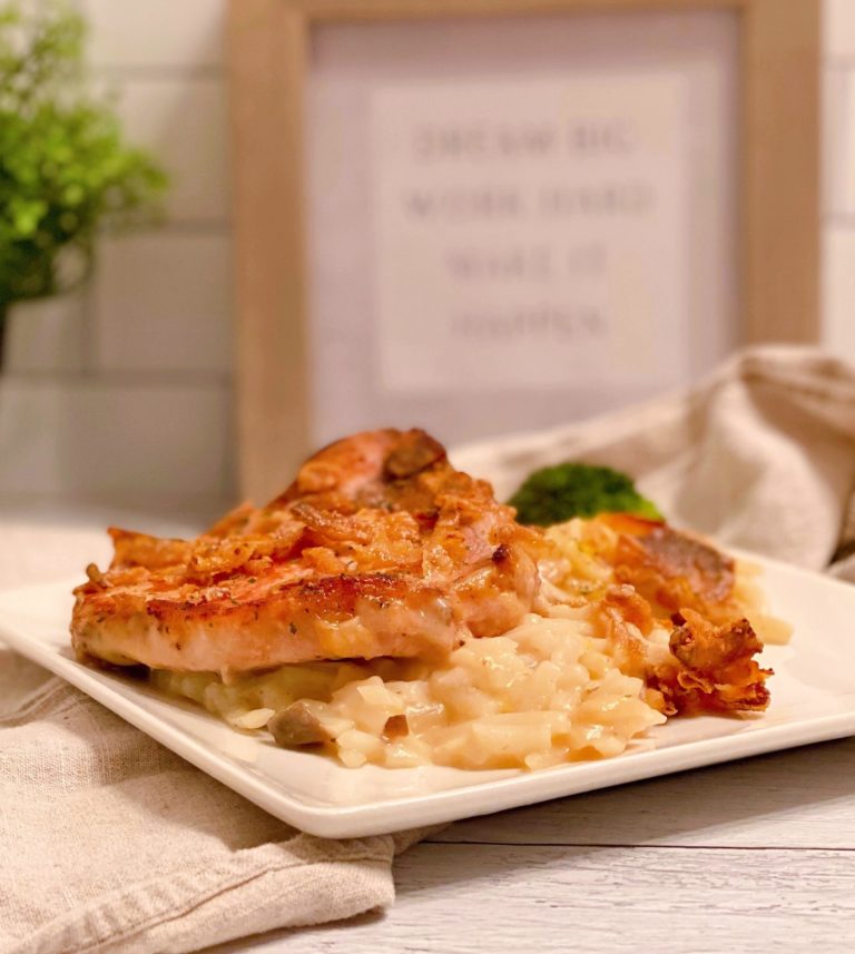Pork Chop and Potatoes on a serving plate ready to eat.