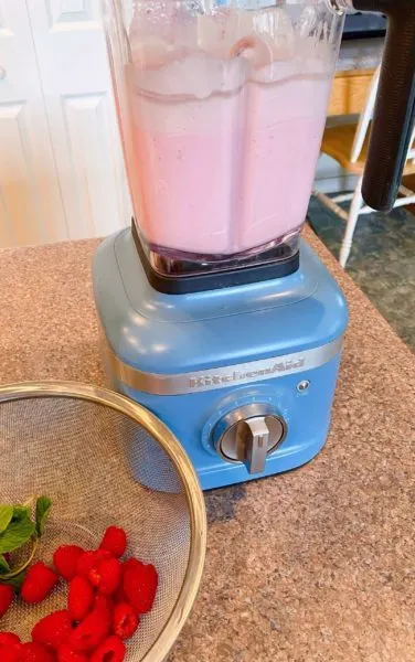 Raspberry Milkshake mixed up in blender ready to serve. 