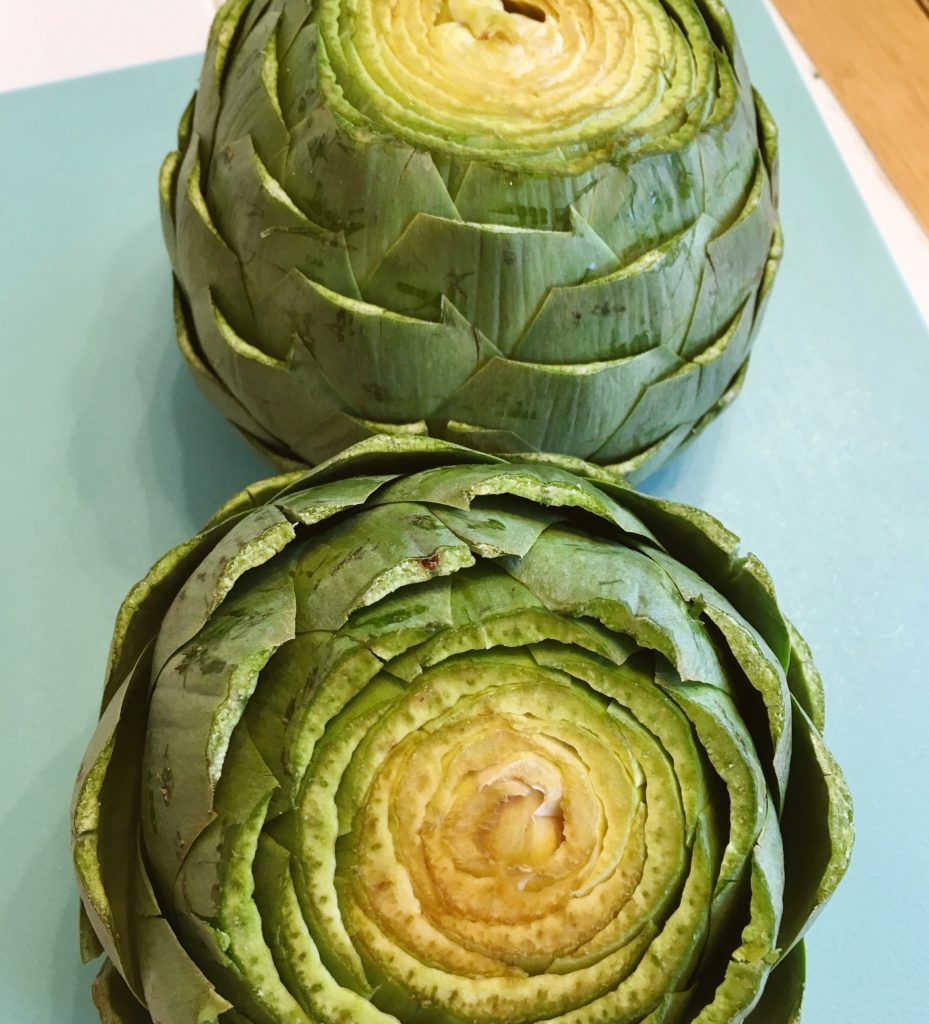 Prepared artichokes cut and ready to steam.