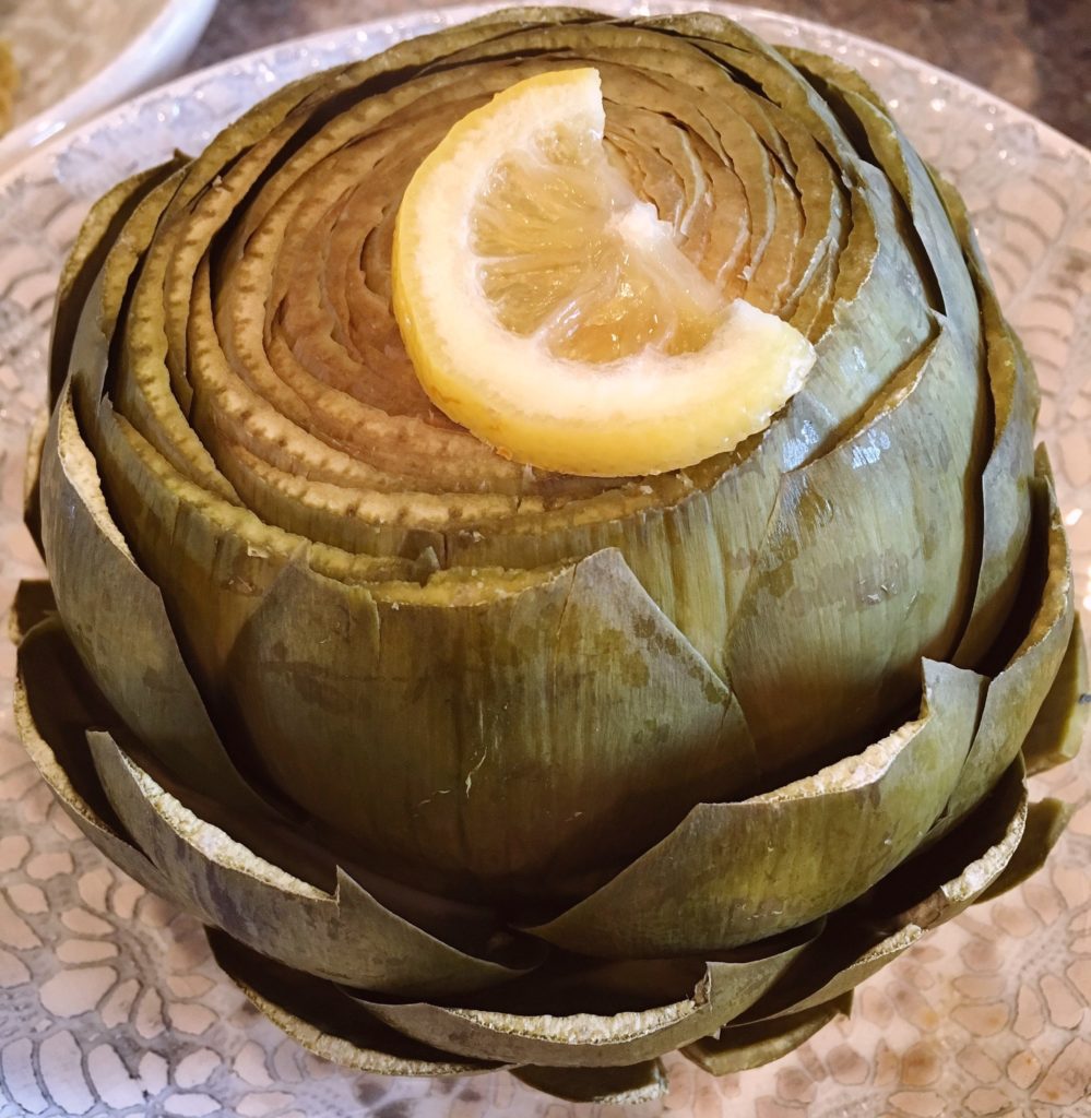 Cooked artichokes in a serving bowl