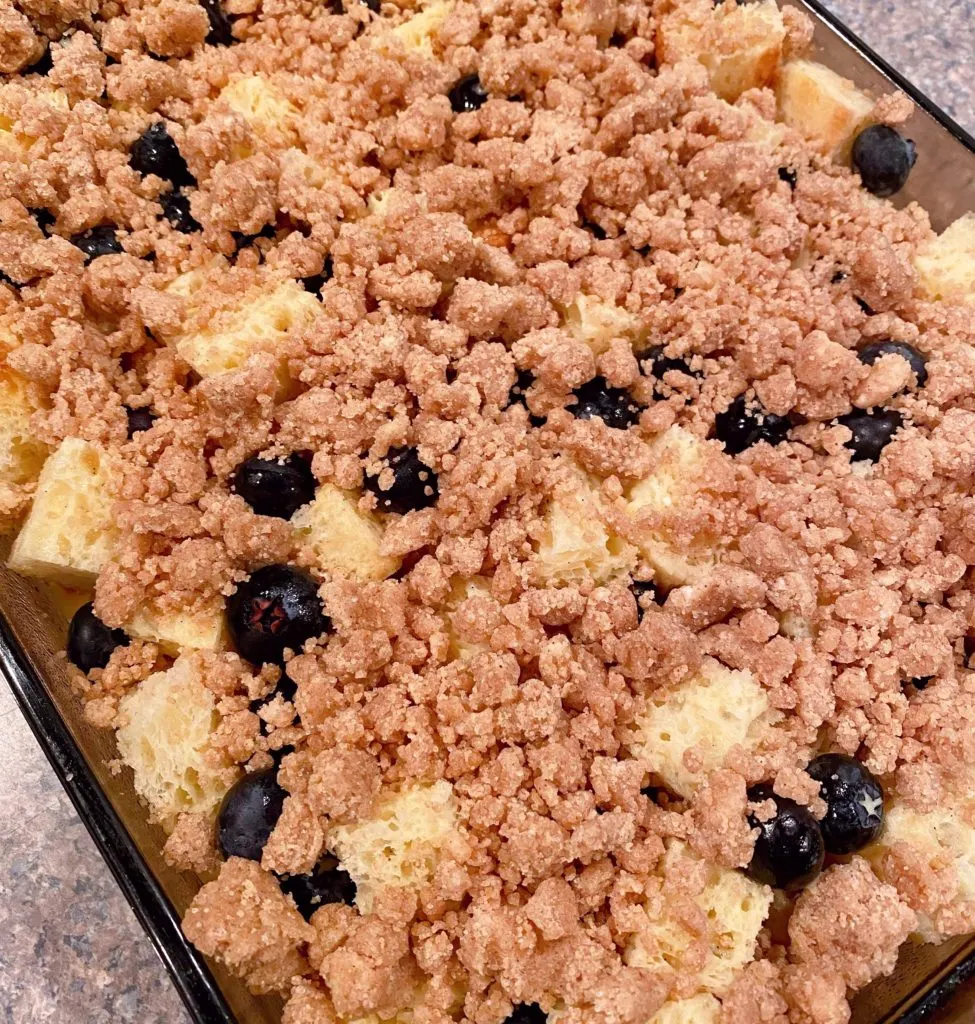 Adding crumb topping on top of casserole.