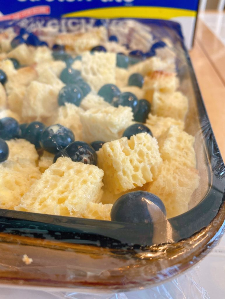 Casserole dish covered with saran wrap ready to refrigerate.