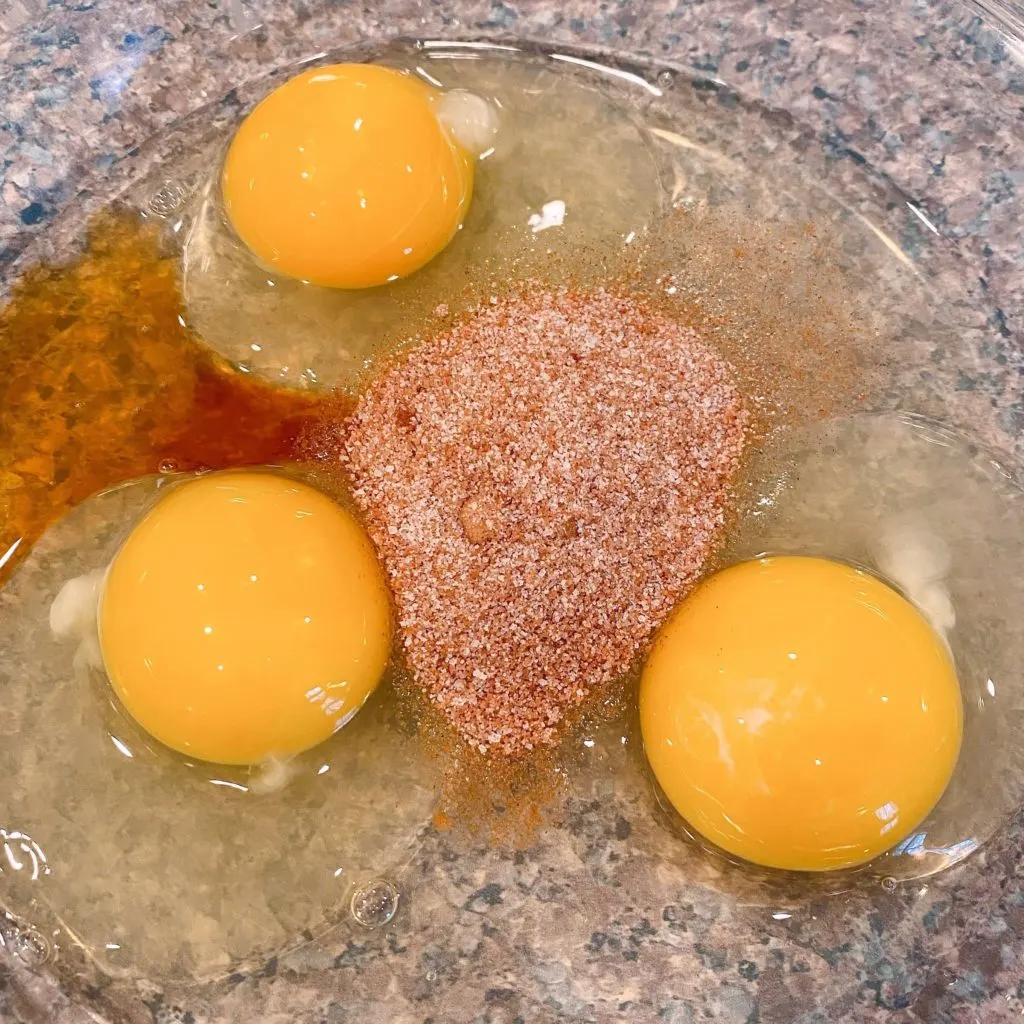 Shallow pie plate with eggs, cinnamon, sugar, and vanilla. 